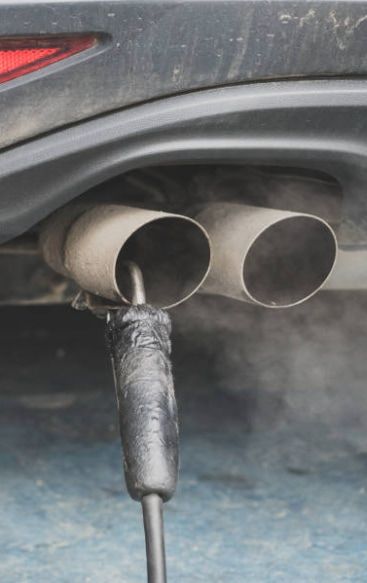 Smog test probe inserted in a car’s dual exhaust tailpipes