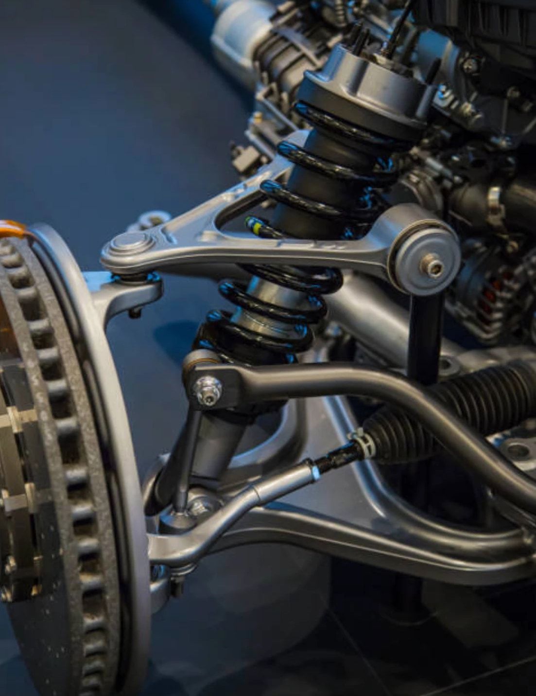 Front suspension assembly with coil-over shock, control arms and brake rotor